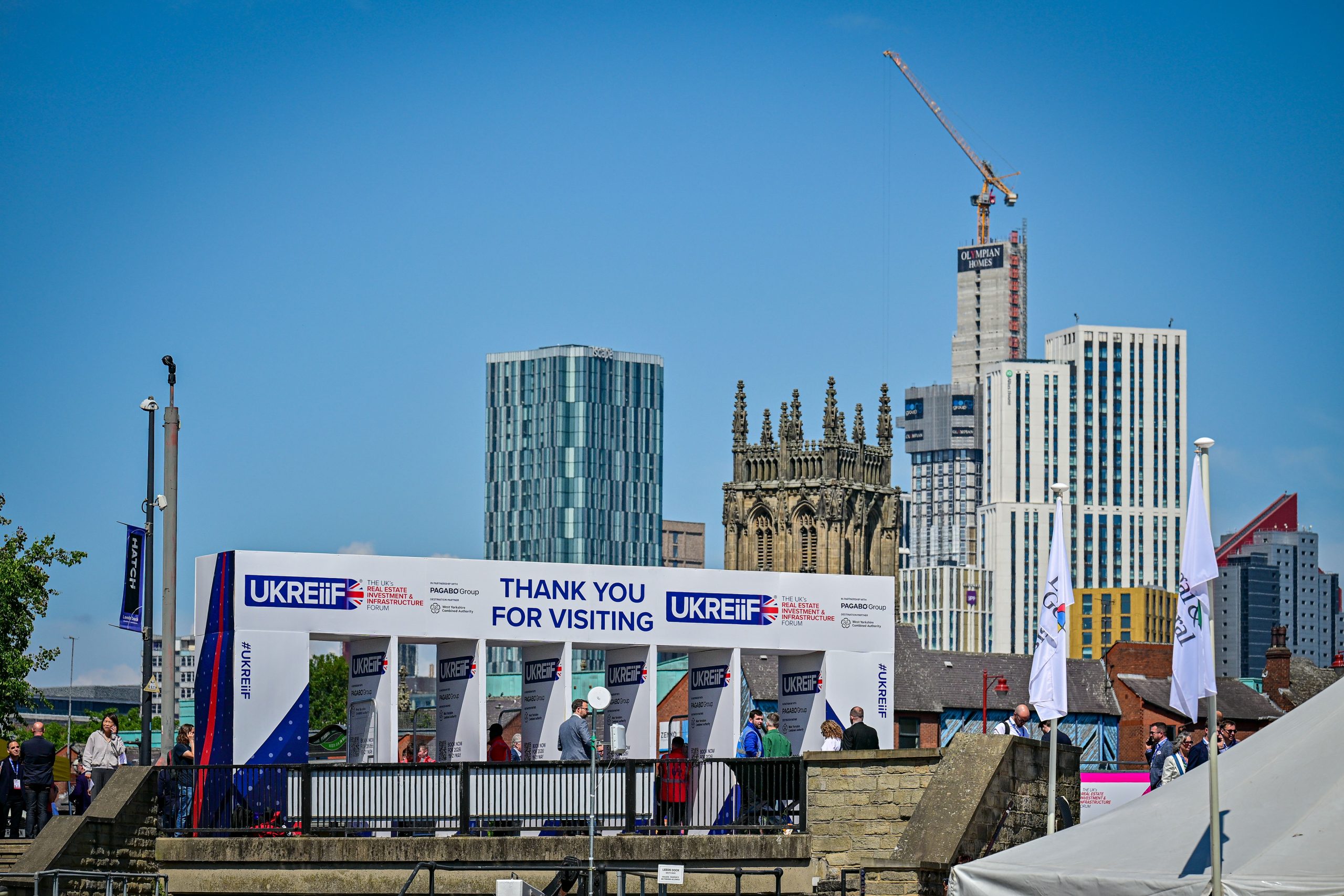 UKREiiF conference entrance in front of the Leeds skyline which includes tall, modern and traditional buildings